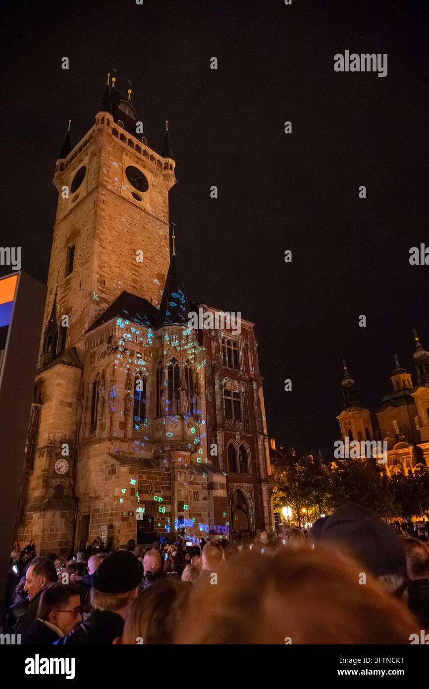 Lettere e simboli animati illuminano la facciata gotica del Municipio della Città Vecchia di Praga mentre le folle partecipano al Festival Signal 2026. Foto Stock