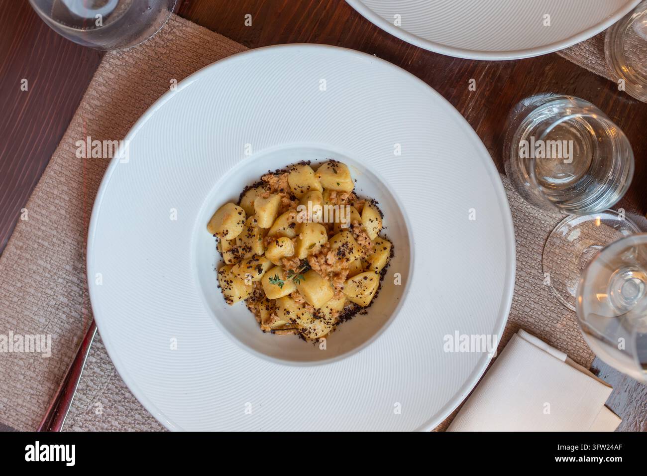 Piatto elegante di gnocchi di patate con ricca salsa di ragù di carne in un ristorante gastronomico Foto Stock
