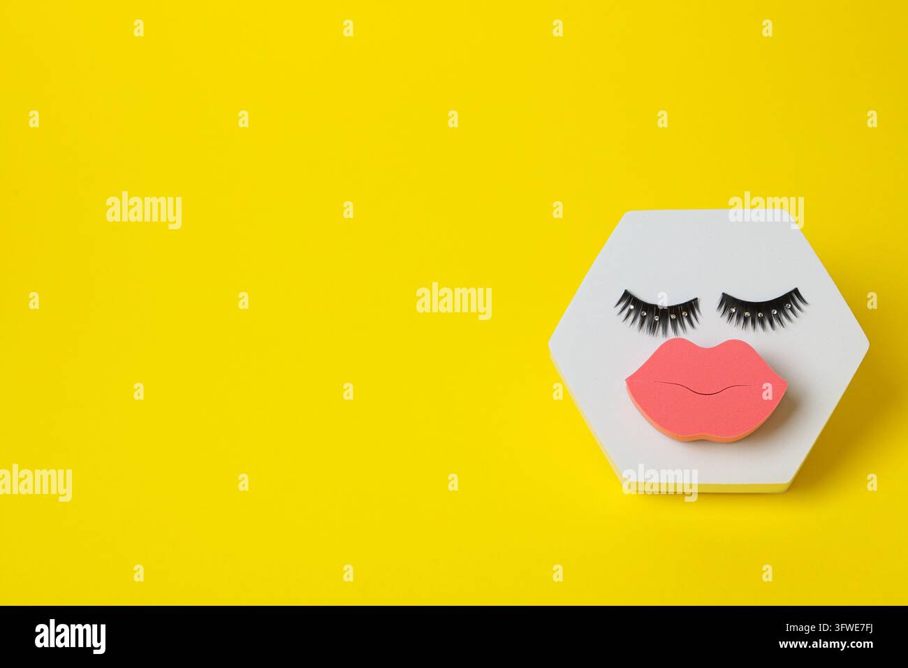 Spugna cosmetica e ciglia finte su sfondo giallo, spazio per il testo Foto Stock