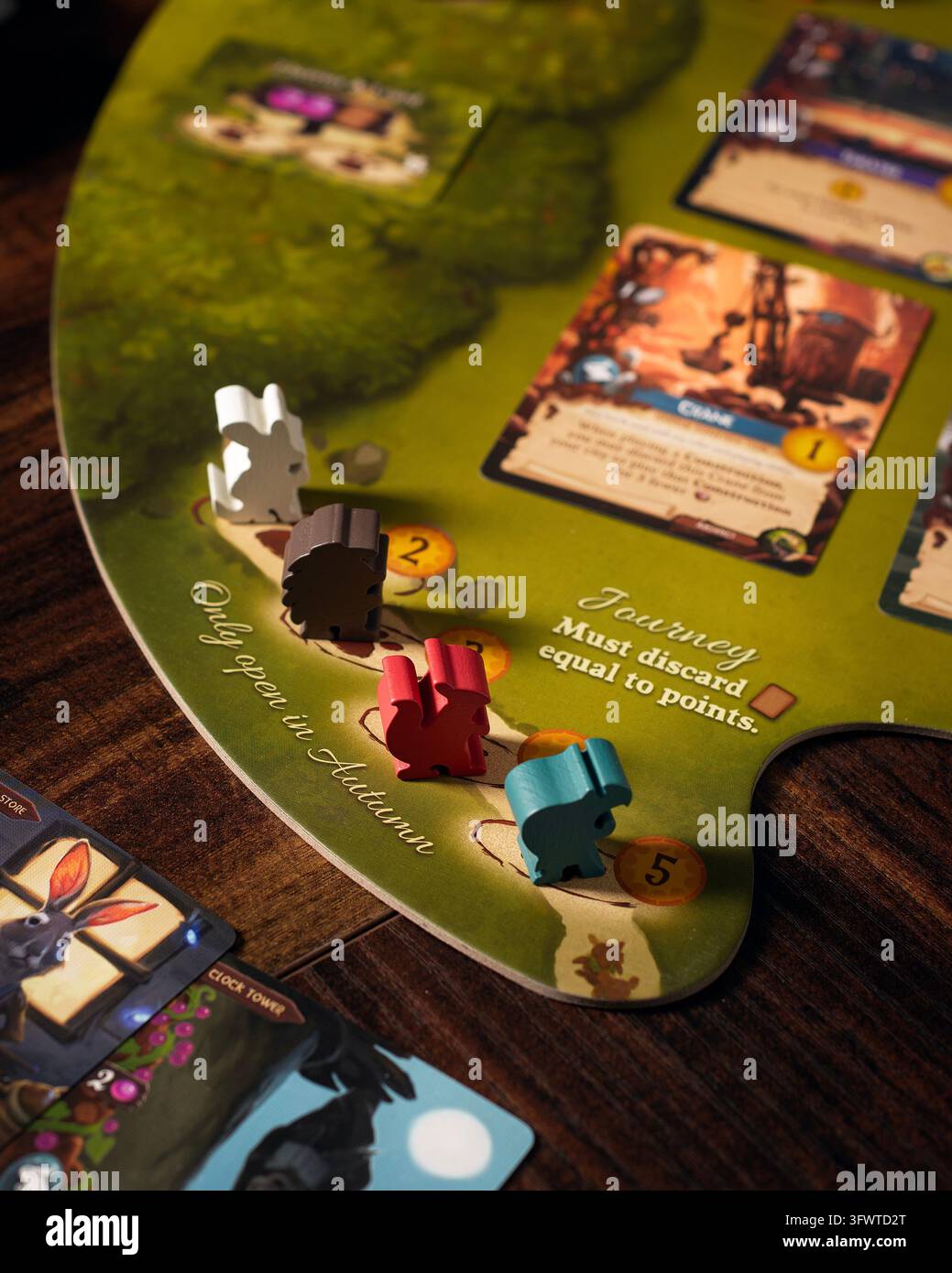 Queretaro, Queretaro, 10 10 2026. Componenti del gioco da tavolo Everdell esposti sulla superficie di gioco sotto una luce drammatica. Ritratto in primo piano che mostra th Foto Stock
