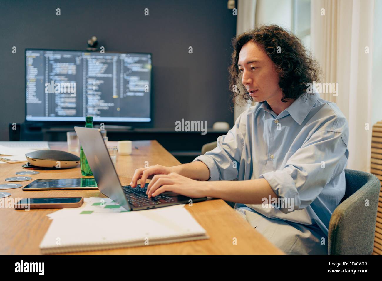 Programmatore che analizza il lavoro sul monitor, programmatore che studia i risultati della programmazione durante una sessione di pianificazione delle attività Foto Stock