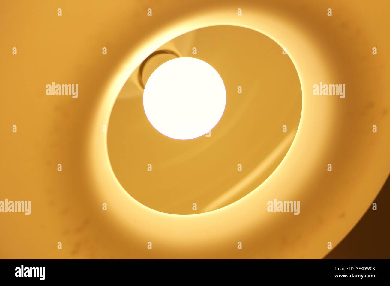 Prima piano di una lampada a sospensione interna sferica luminosa con sfondo sfocato caldo Foto Stock