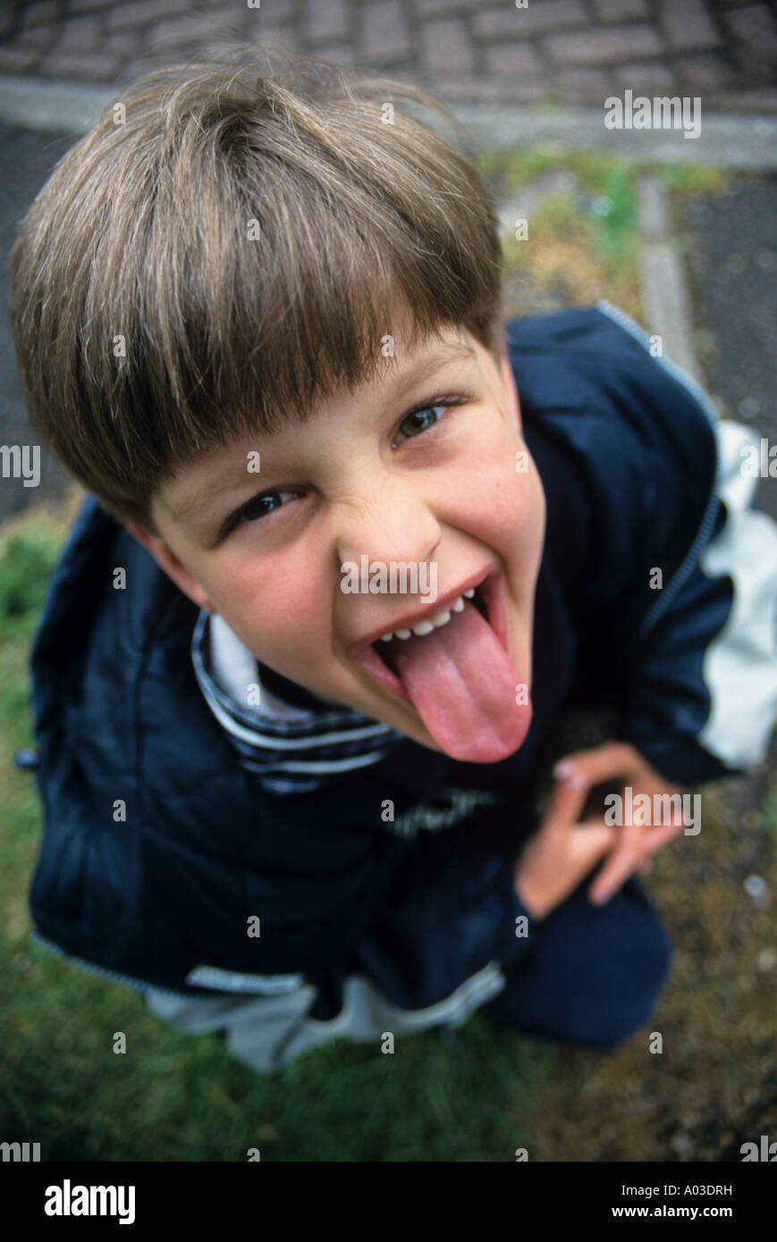 Modello rilasciato Ragazzo spuntavano lingua Foto Stock