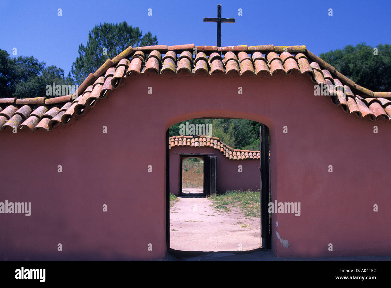 Porta che conduce ad un altra porta de La Purisima missione con lo stucco rosa pareti e tetto di tegole rosse e. Foto Stock