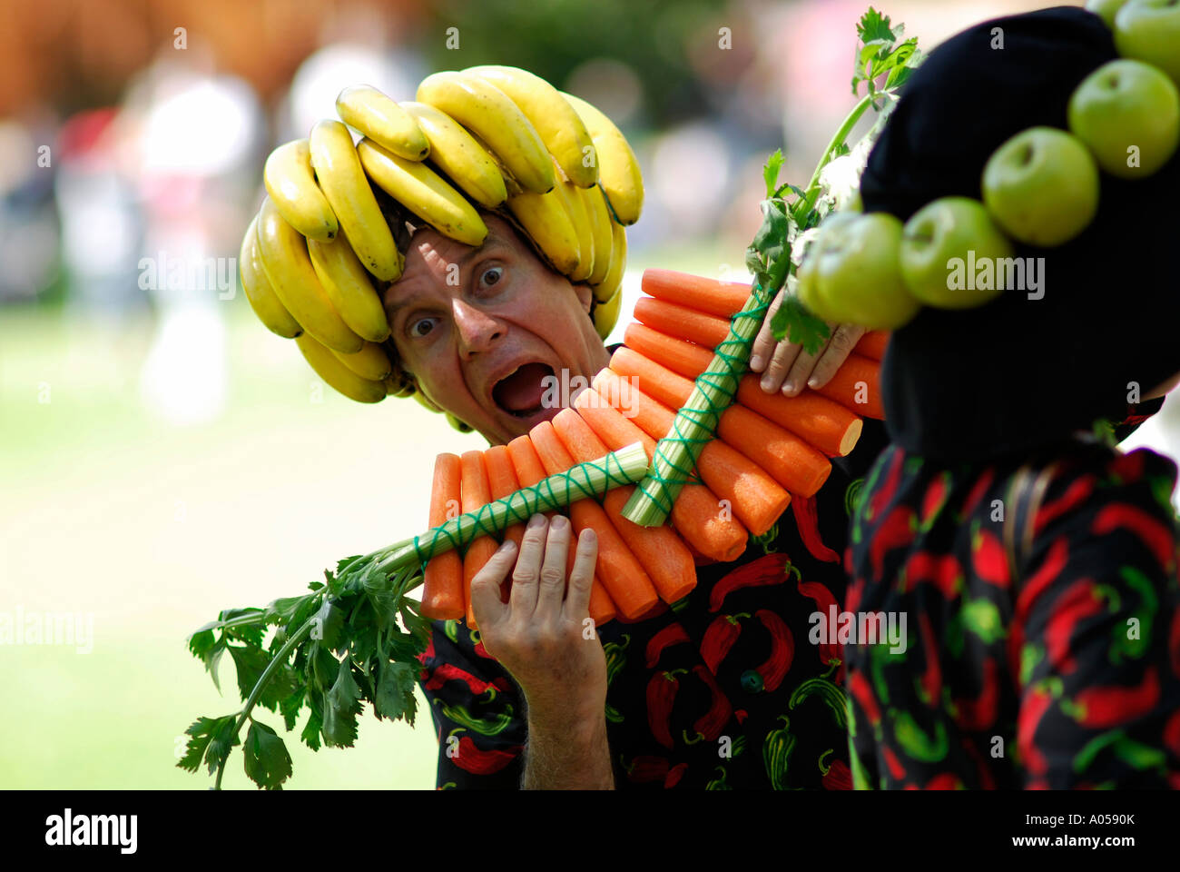 Uomo che indossa crudo fresco frutta e verdura, riproduzione di pan-tubi fatti di carote Foto Stock