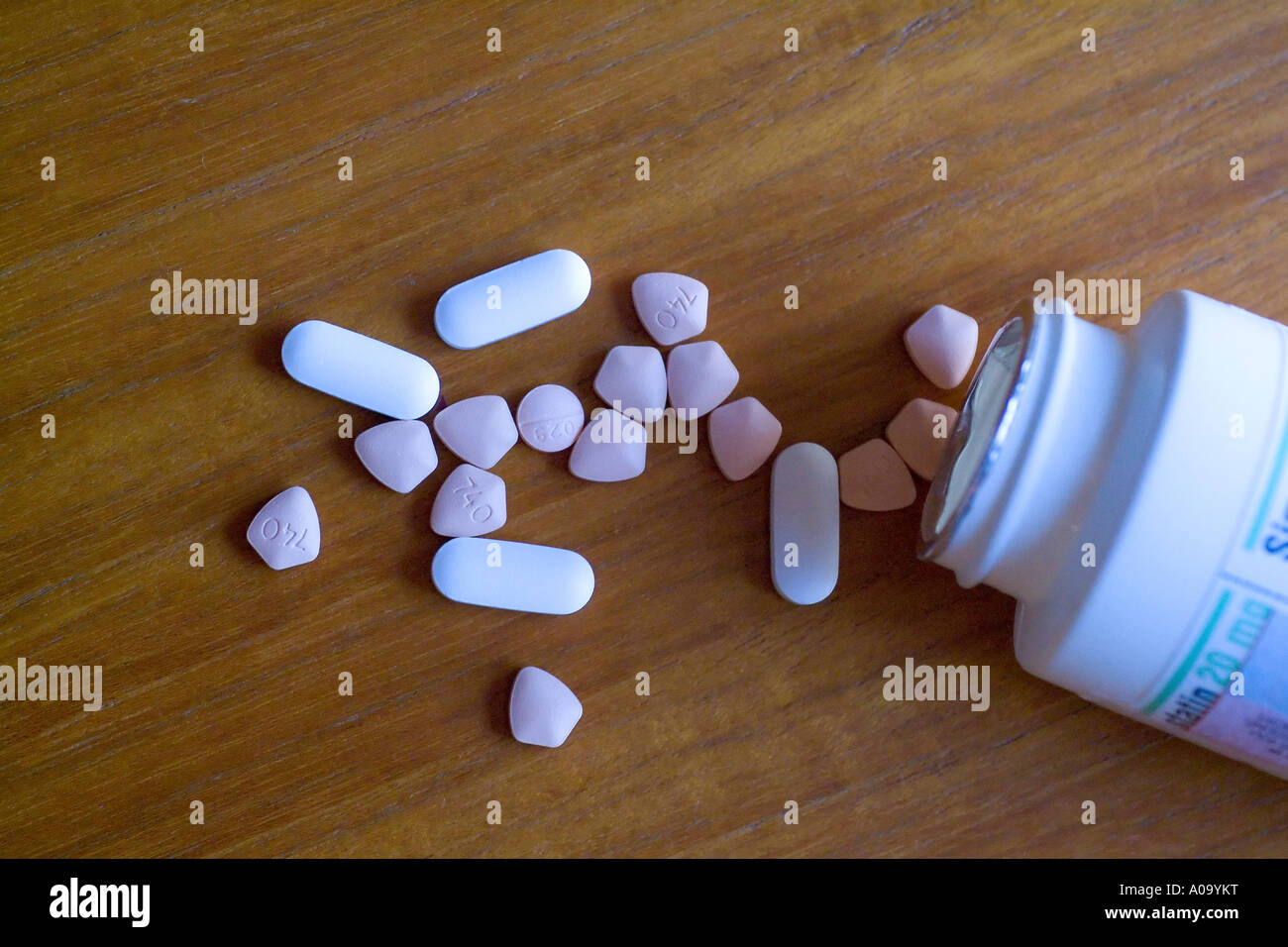 Pillole la fuoriuscita di una bottiglia di prescrizione su un tavolo Foto Stock