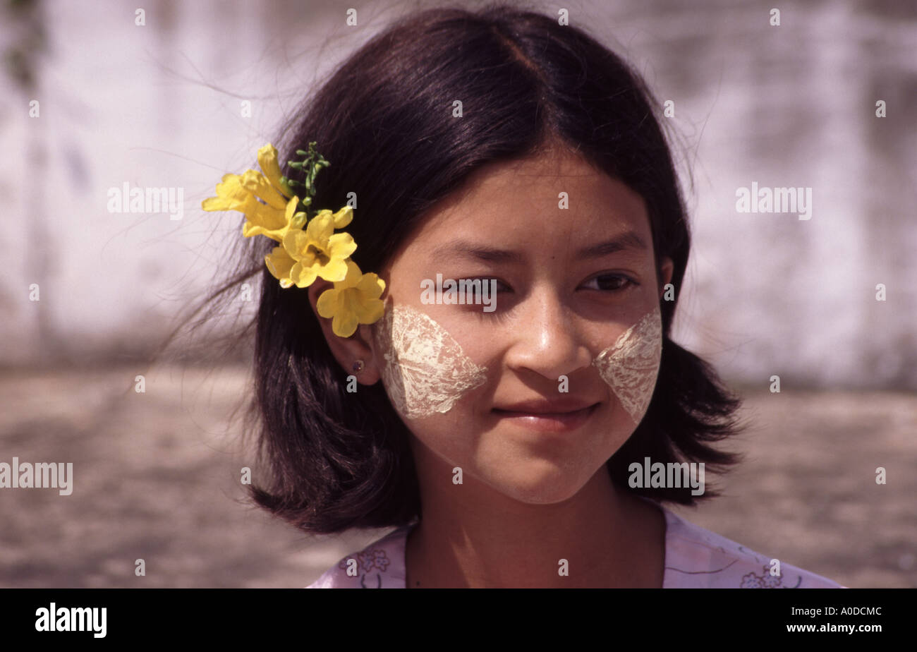 Giovane ragazza birmano con Tanaka e fiore nei suoi capelli Foto Stock