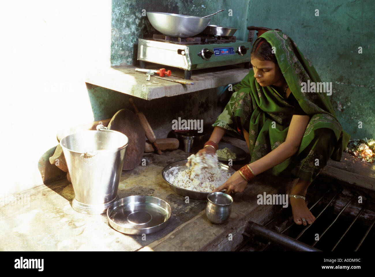 Stile di vita indiano una giovane donna cuochi un pasto di base nella nuda  cucina di una casa privata Varanasi Uttar Pradesh, India Foto stock - Alamy