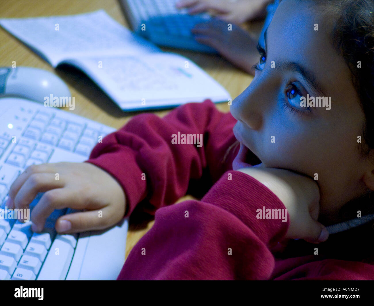 Tastiera per computer della scuola junior in classe primo piano su studentessa studentessa studentessa studentessa spagnola annoiata di 6-8 anni che sbadiglia in classe di computer della scuola Foto Stock