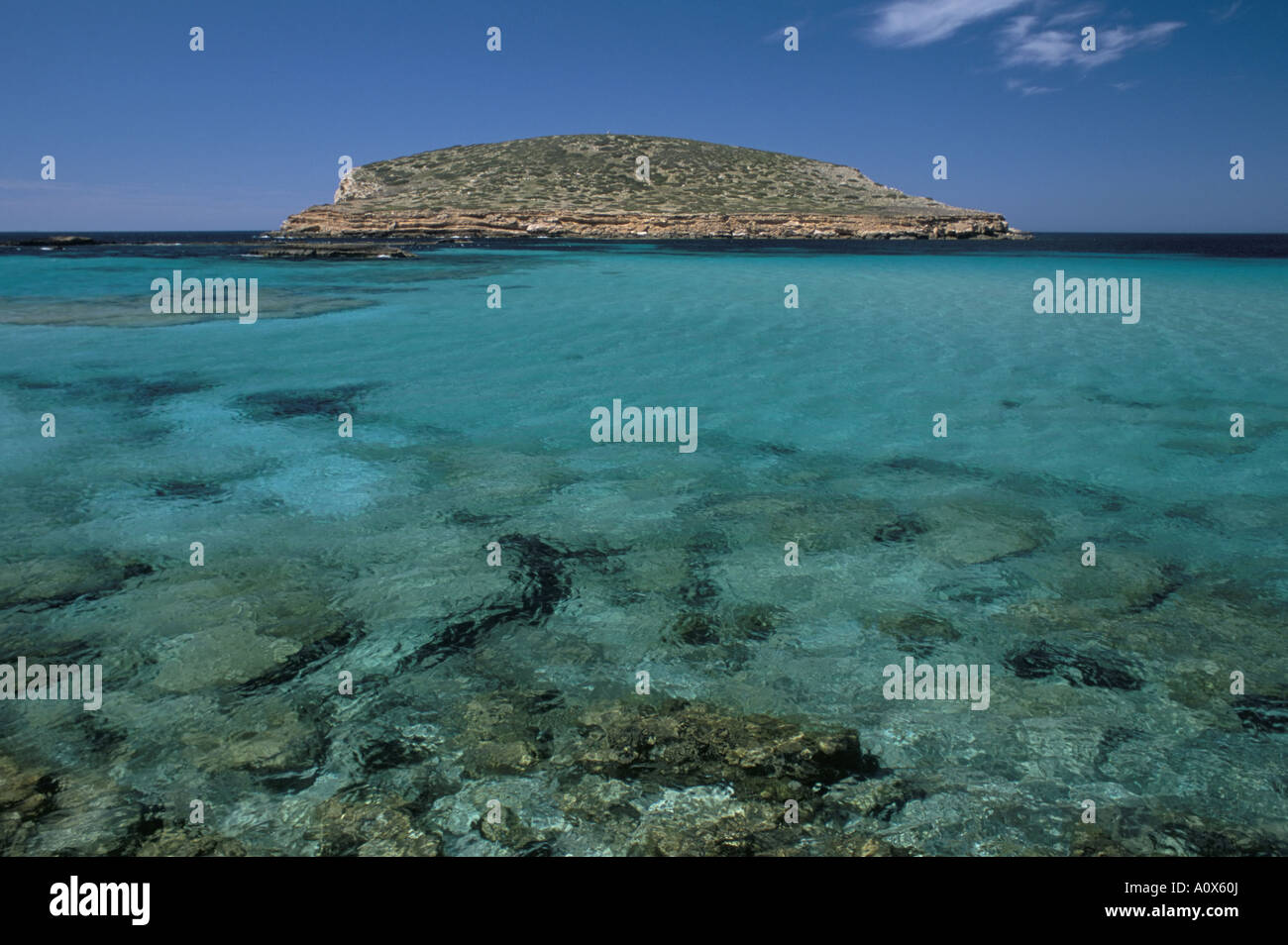 Cala Comta e l'isolotto roccioso di Illa d es Bosc vicino a Sant Antoni Ibiza Isole Baleari Spagna Europa Mediterranea Foto Stock