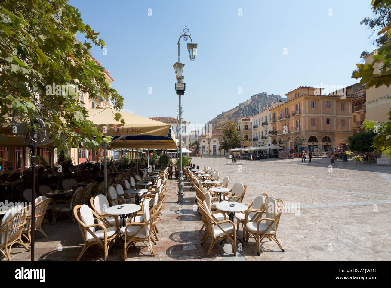 Cafe in Piazza Syntagma (la piazza principale) con Palamidi Castle in distanza, Nafplion, Peloponneso, Grecia Foto Stock
