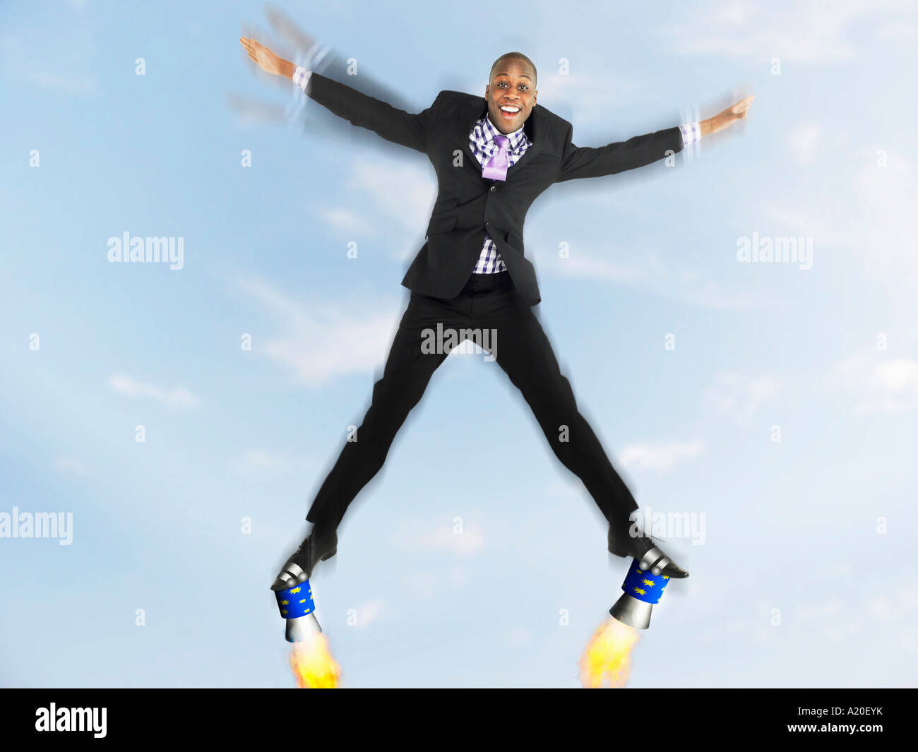 Uomo in tuta jumping in forma a stella con razzi su piedi, composito digitale Foto Stock