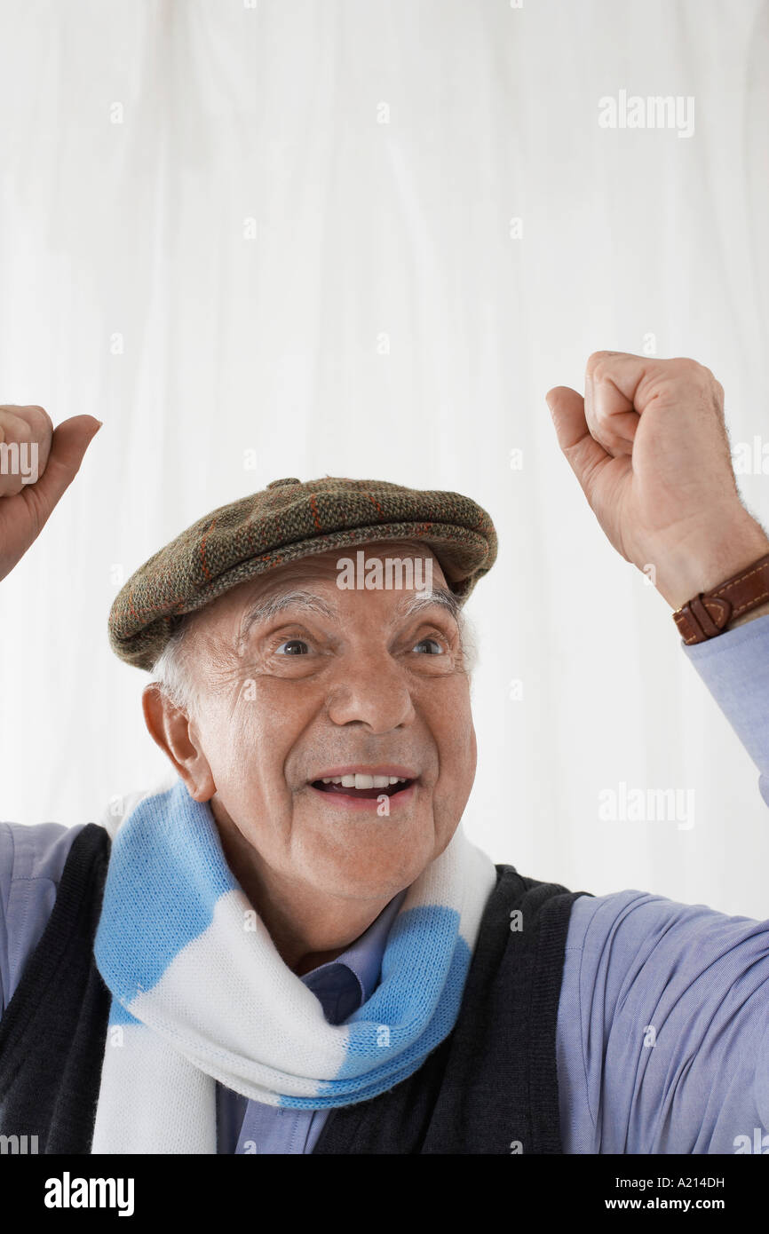 Senior uomo nel calcio sciarpa, celebrando in studio, la testa e le spalle Foto Stock