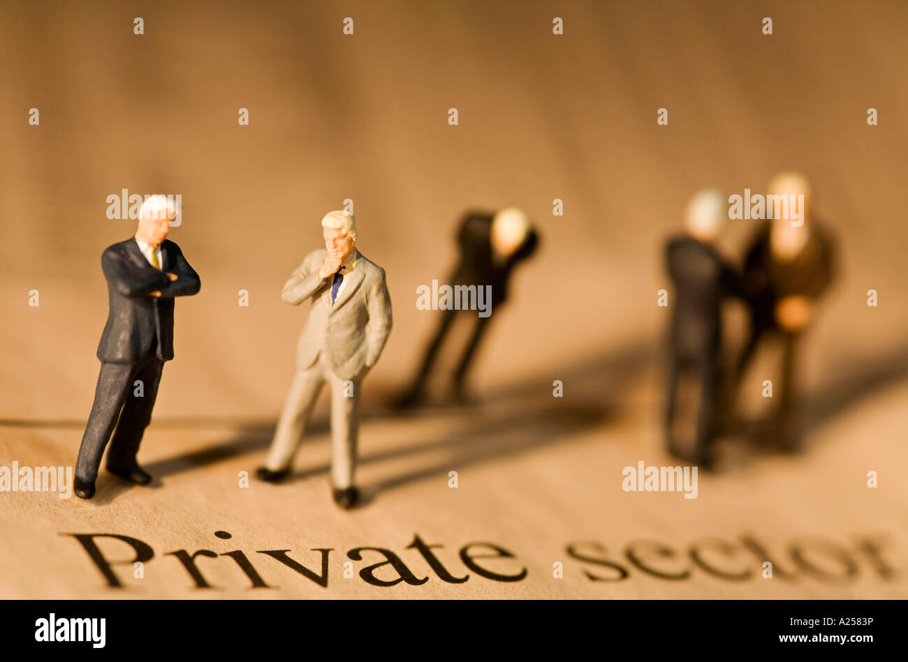 Gli imprenditori in miniatura in piedi sul quotidiano finanziario nella parte anteriore del settore privato headline Foto Stock