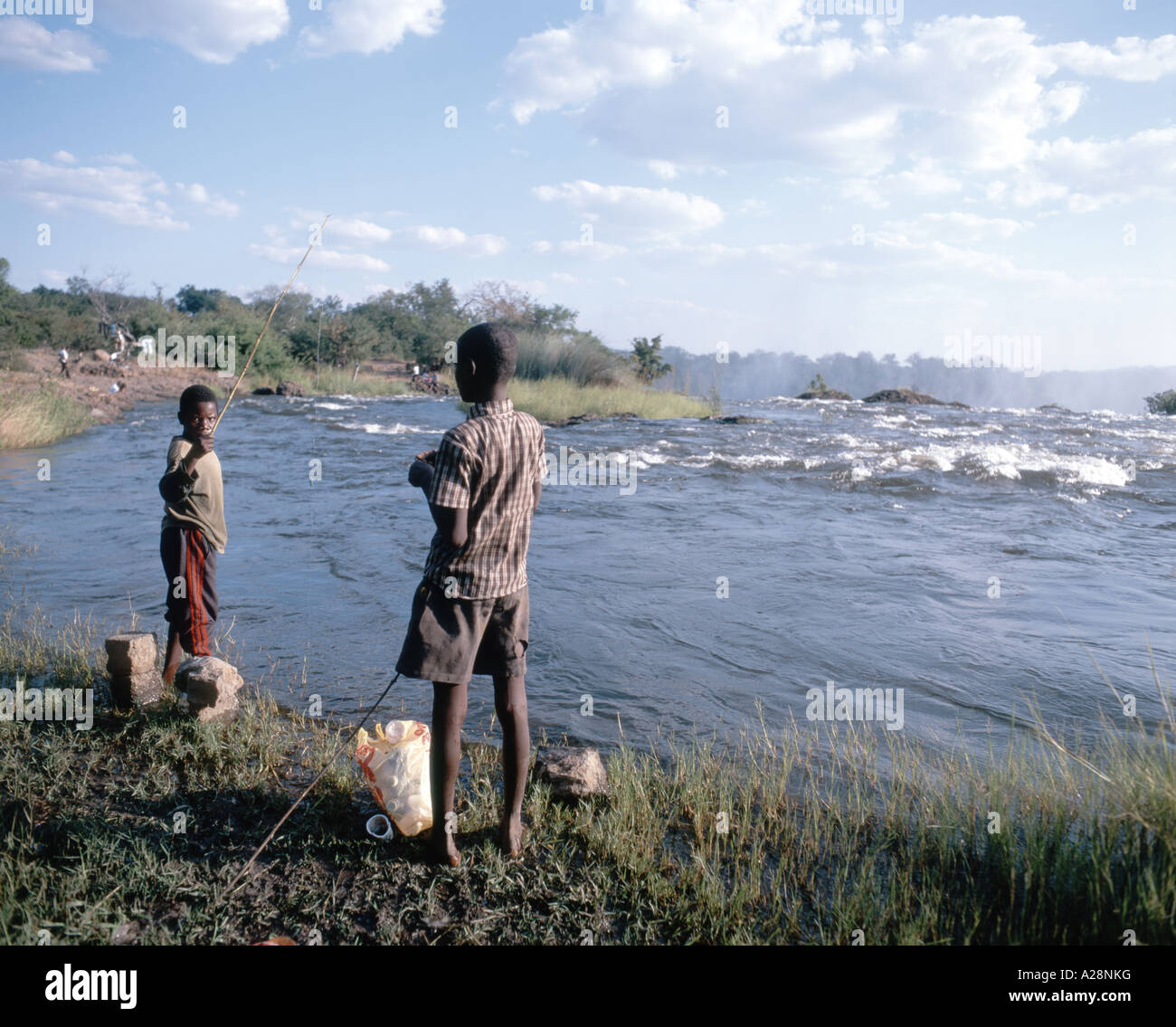 Ragazzi la pesca al top delle cascate Victoria Falls (Mosi-oa-Tunya), Livingstone, sud della provincia, Zambia Foto Stock
