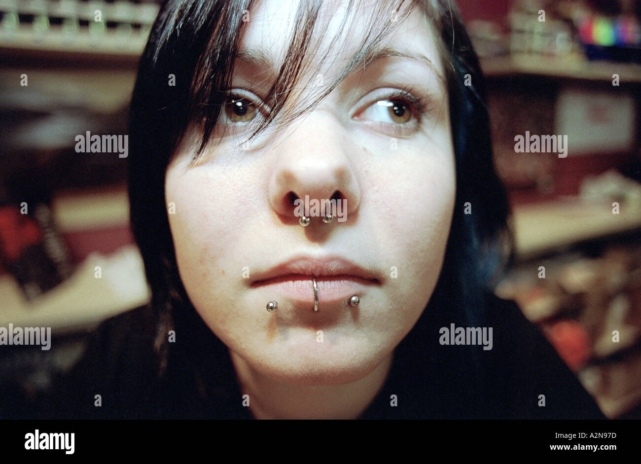 Una giovane ragazza con piercing nel suo viso Foto Stock