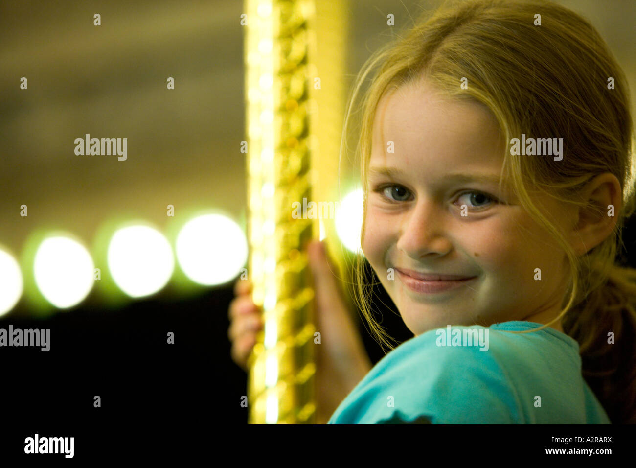 Una giovane ragazza di 10 anni si muove su un Merry Go Round California Stati Uniti d'America Foto Stock