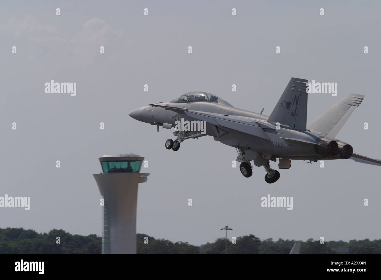 US Navy F-18F Hornet strike fighter prendendo il largo con airport il traffico aereo della torre di controllo Foto Stock