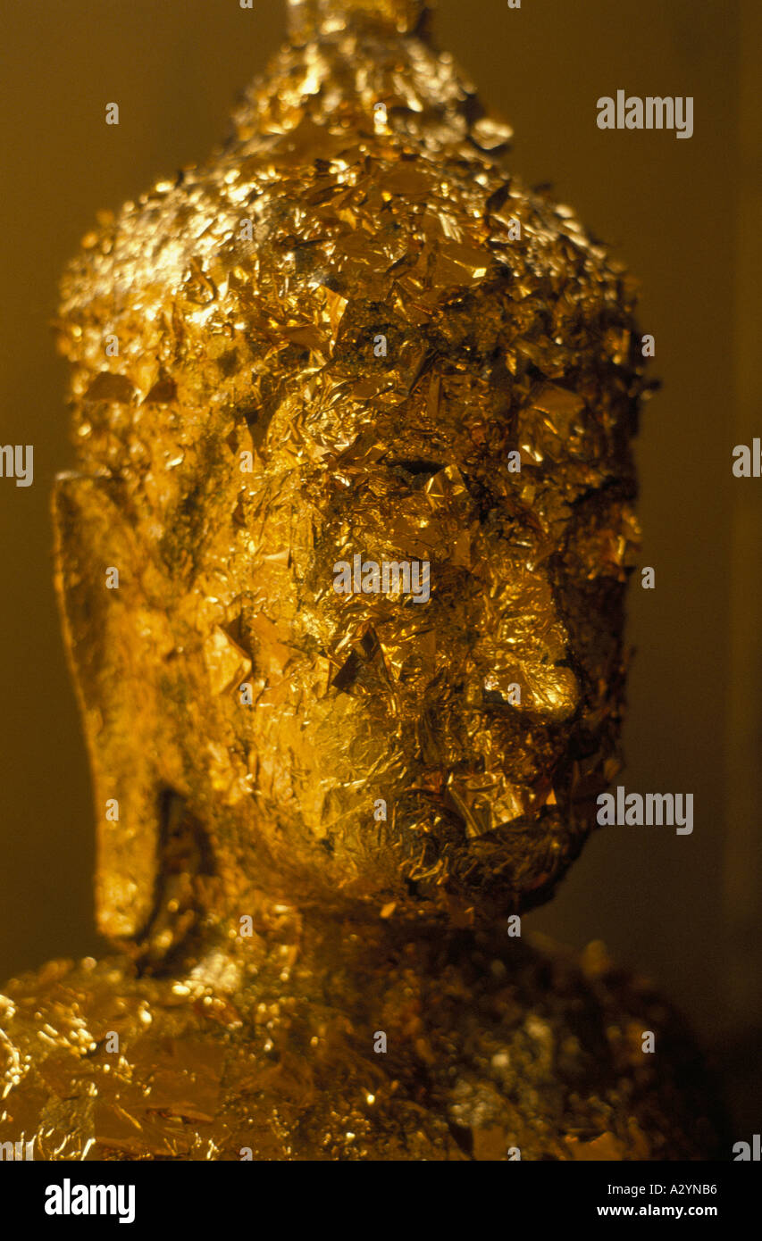 Statua di Buddha. La foglia di oro è attaccato alla faccia come offerta al tempio del Buddha di oro a Bangkok, in Thailandia Foto Stock