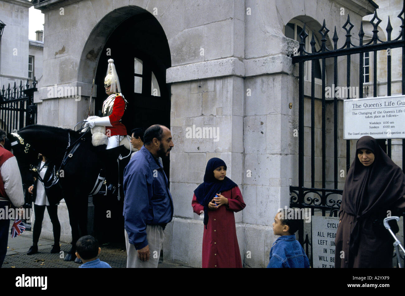 Famiglia musulmana in visita a Londra centrale top vedere il Queens Life Guard in whitehall Foto Stock