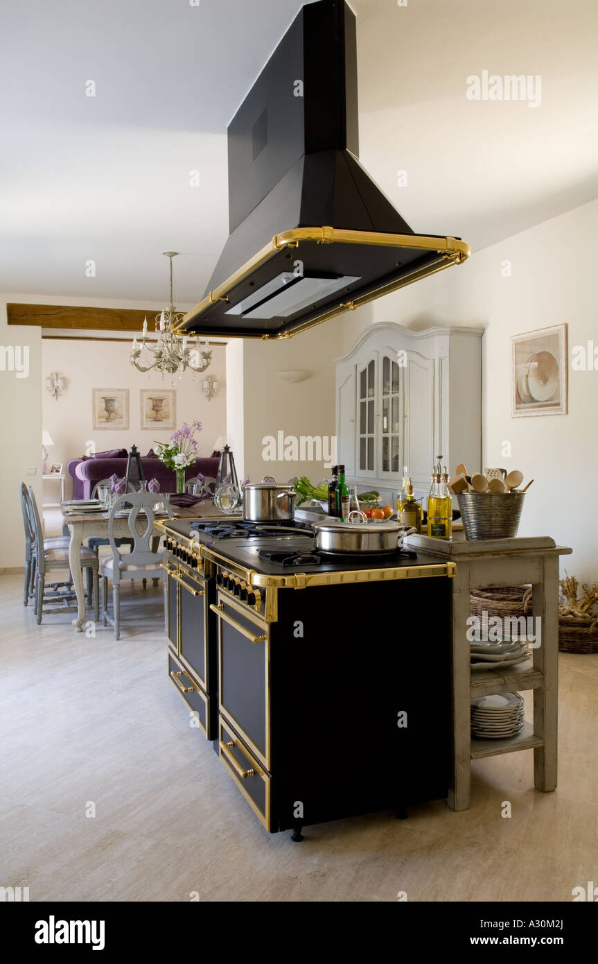 Ornati ventola estrattore su freestanding placcate dorate forno in cucina a pianta aperta Foto Stock