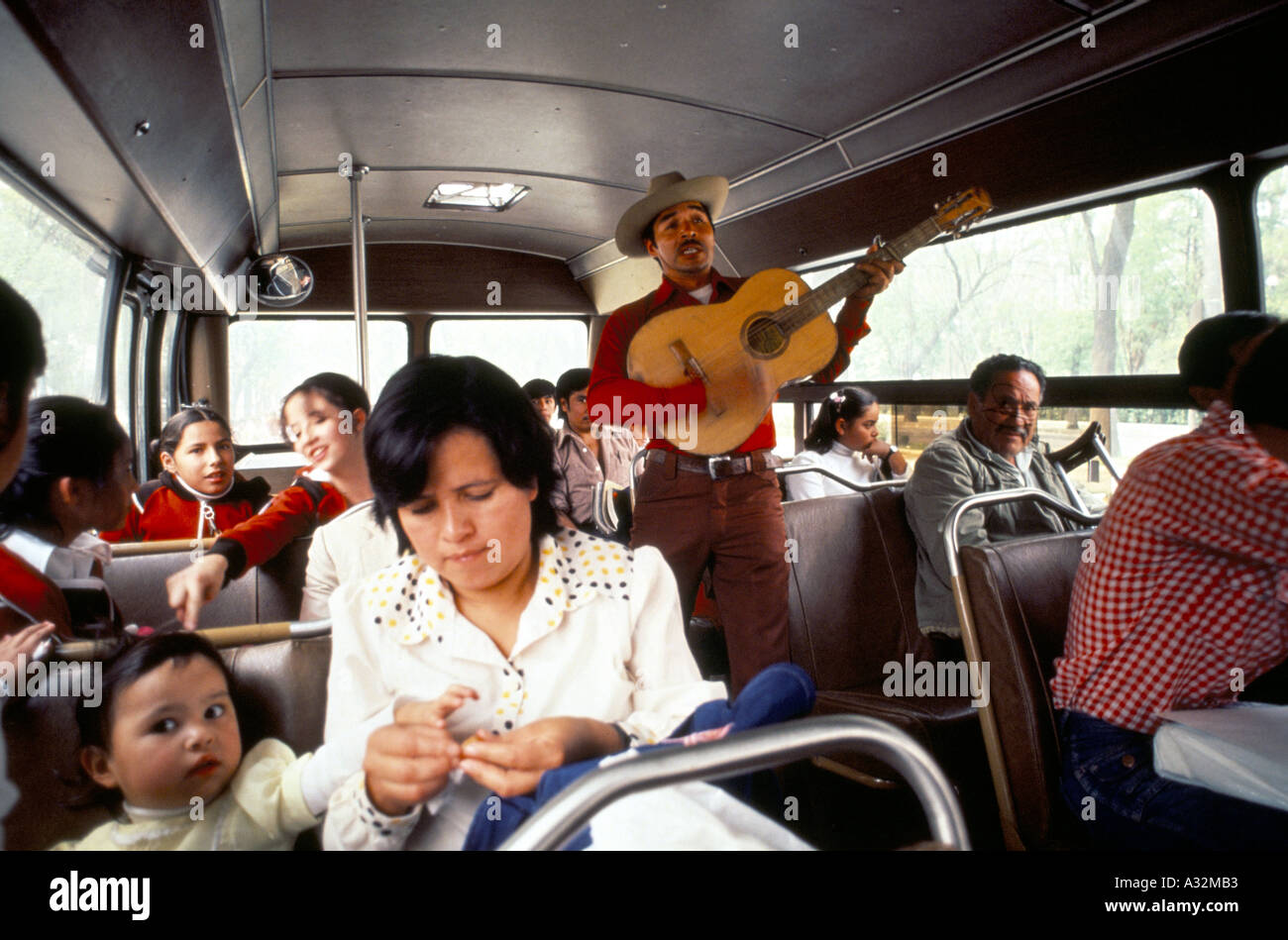 Uomo che sta suonando la chitarra e i passeggeri di un autobus città del Messico MESSICO Foto Stock