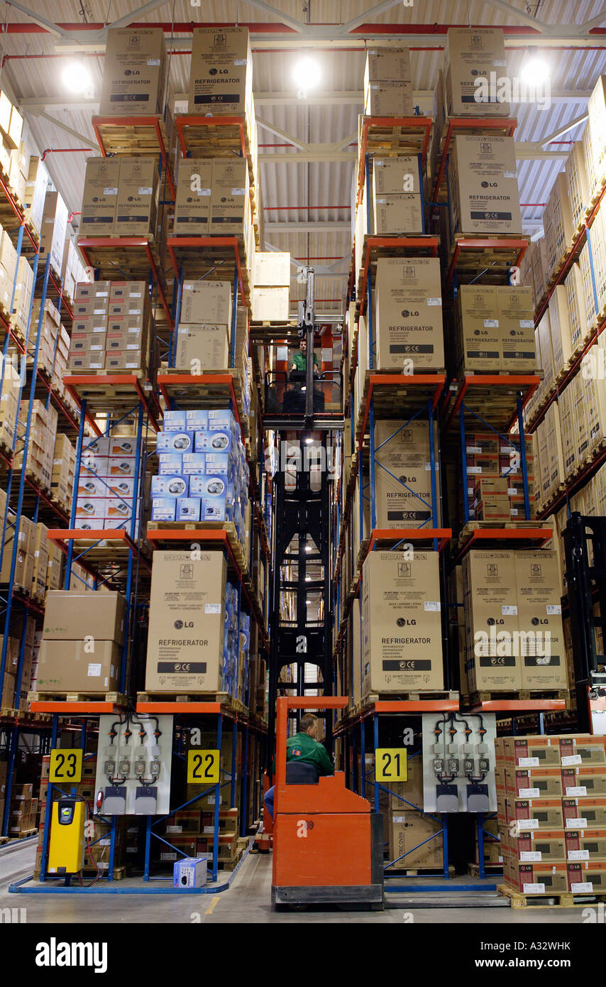 Funzionamento Warehousemen carrelli elevatori in un rack del magazzino, Germania Foto Stock