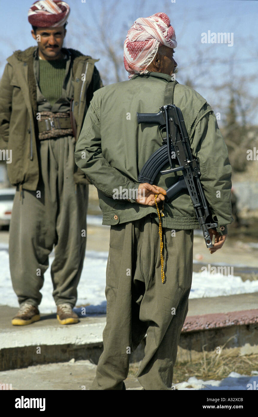 Un combattente Peshmerge portando un AK47 sulla sua schiena, tenendo i grani di preghiera nella sua mano. Il Kurdistan 1993 Foto Stock