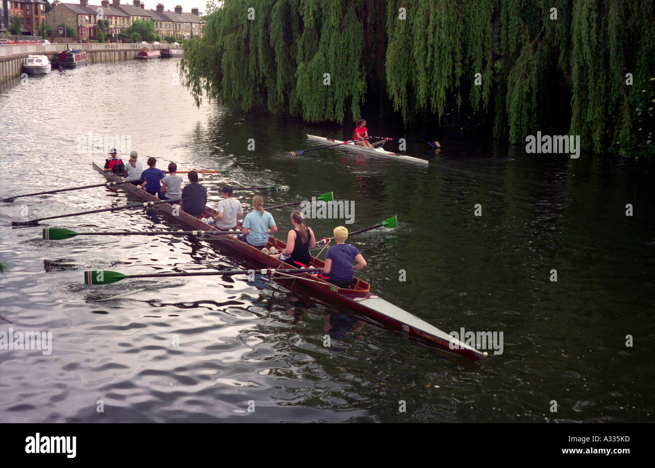 I rematori su una università womens equipaggio del team passa una sola scull lungo il fiume Cam in Cambridge Inghilterra England Foto Stock