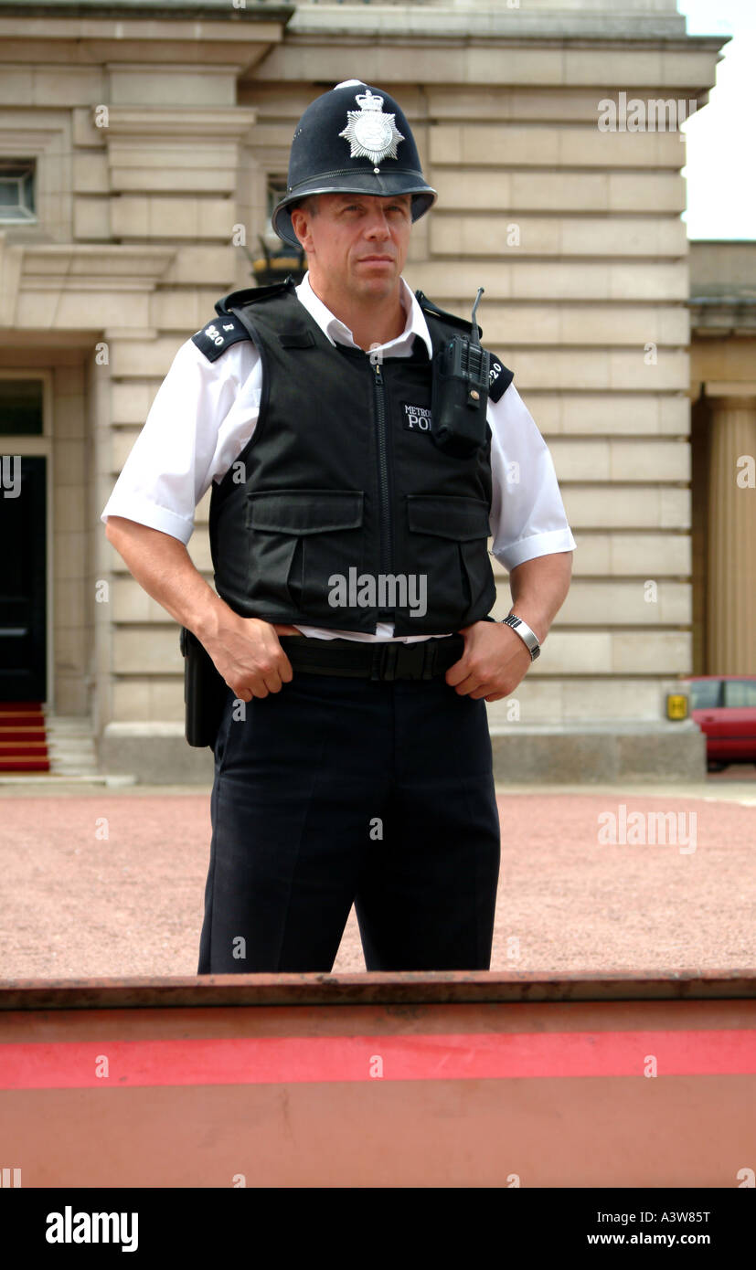 Poliziotto con giubbotti antiproiettile e una radio fuori Buckingham Palace di Londra Foto Stock