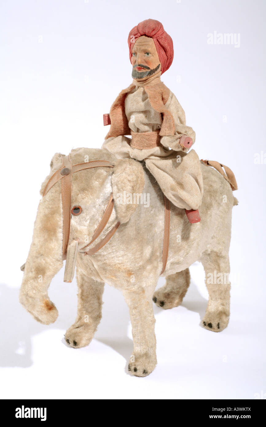 Foto di un vecchio elefante giocattolo con un atleta che indossa un turbante Foto Stock