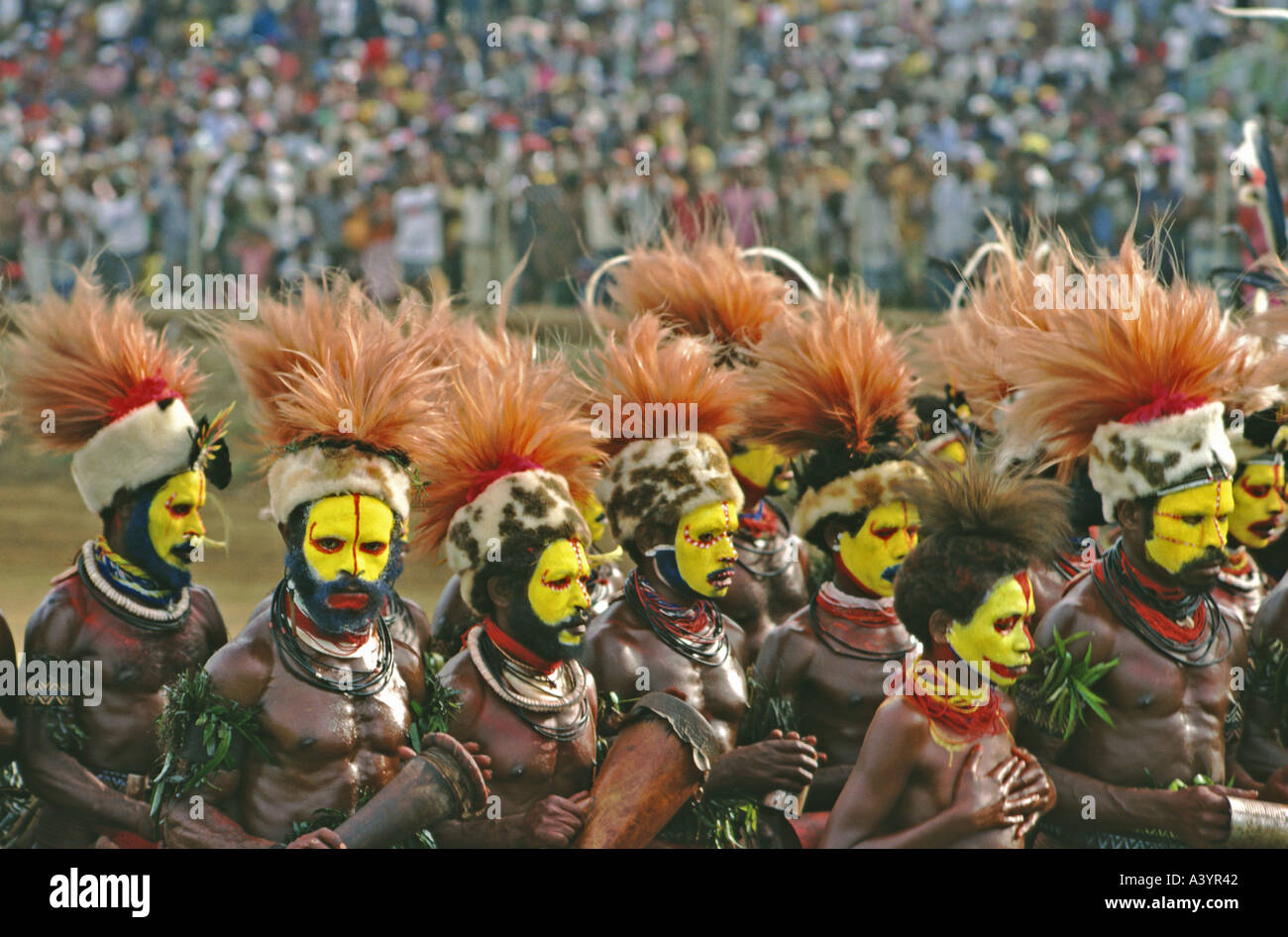 Un dipinto e piumati troupe di Huli guerrieri di eseguire a cantare cantare a Port Moresby in Papua Nuova Guinea Foto Stock