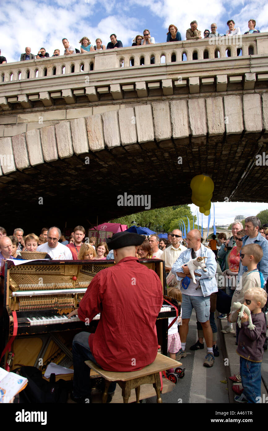 Francia Ile de France Paris Paris Plage spiaggia urbana. Pianoforte giocatore divertente la folla a piedi lungo la Voie Georges Pompidou Foto Stock