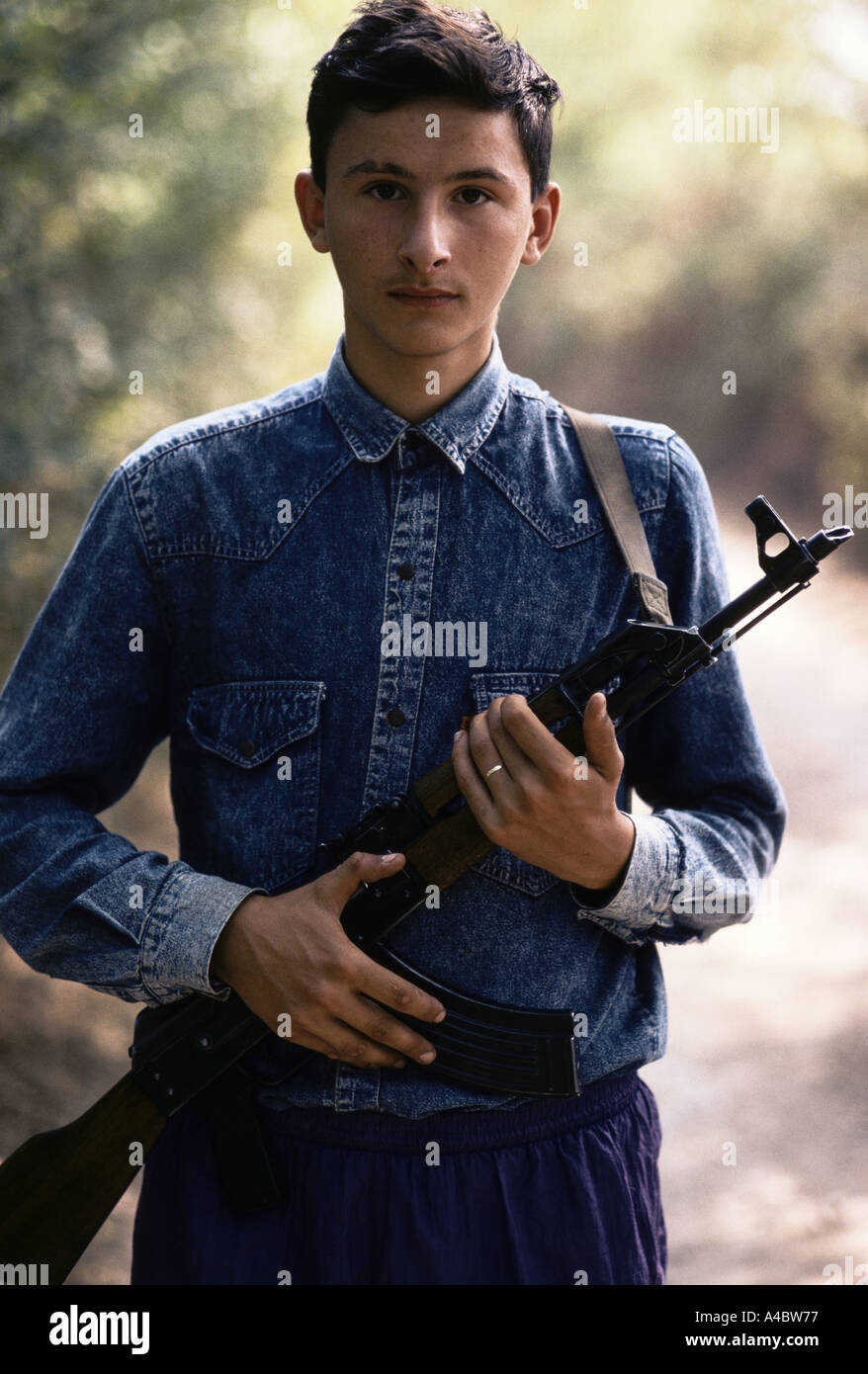 Serbo-bosniaco ragazzo adolescente holding fucile Kalashnikov, vicino a Zvornik linea anteriore, settembre 1992. Foto Stock