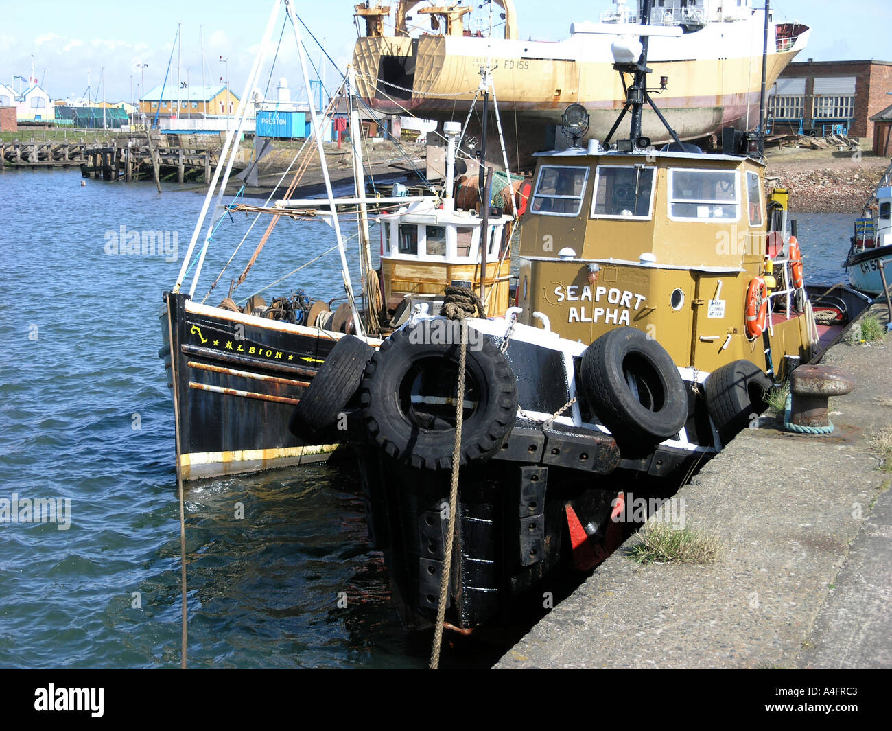 Imbarcazioni ormeggiate al fianco di quay in Fleetwood Dock di pesce Foto Stock