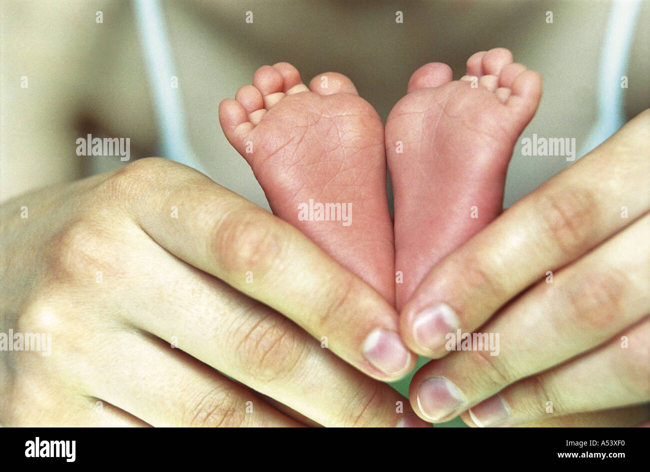 Madre teneramente contiene piccoli piedini del suo bambino la Russia Foto Stock