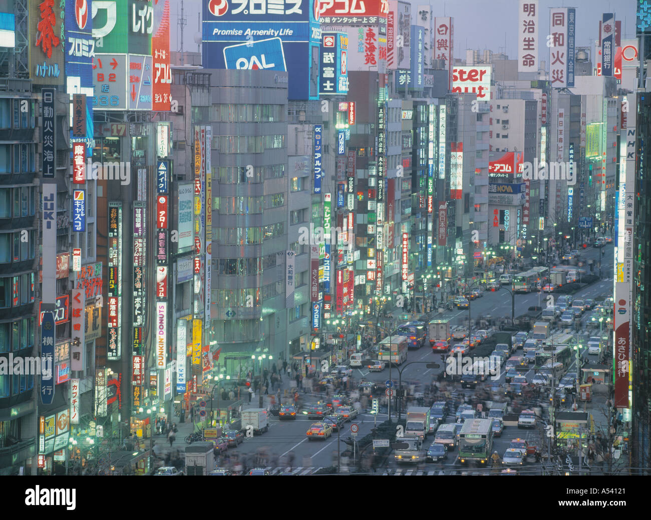 Insegne al neon e il traffico nel quartiere di Shinjuku di Tokyo Foto Stock