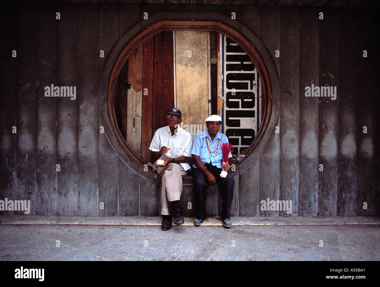 Due vecchi uomini cubani di sedersi su un Havana street Foto Stock
