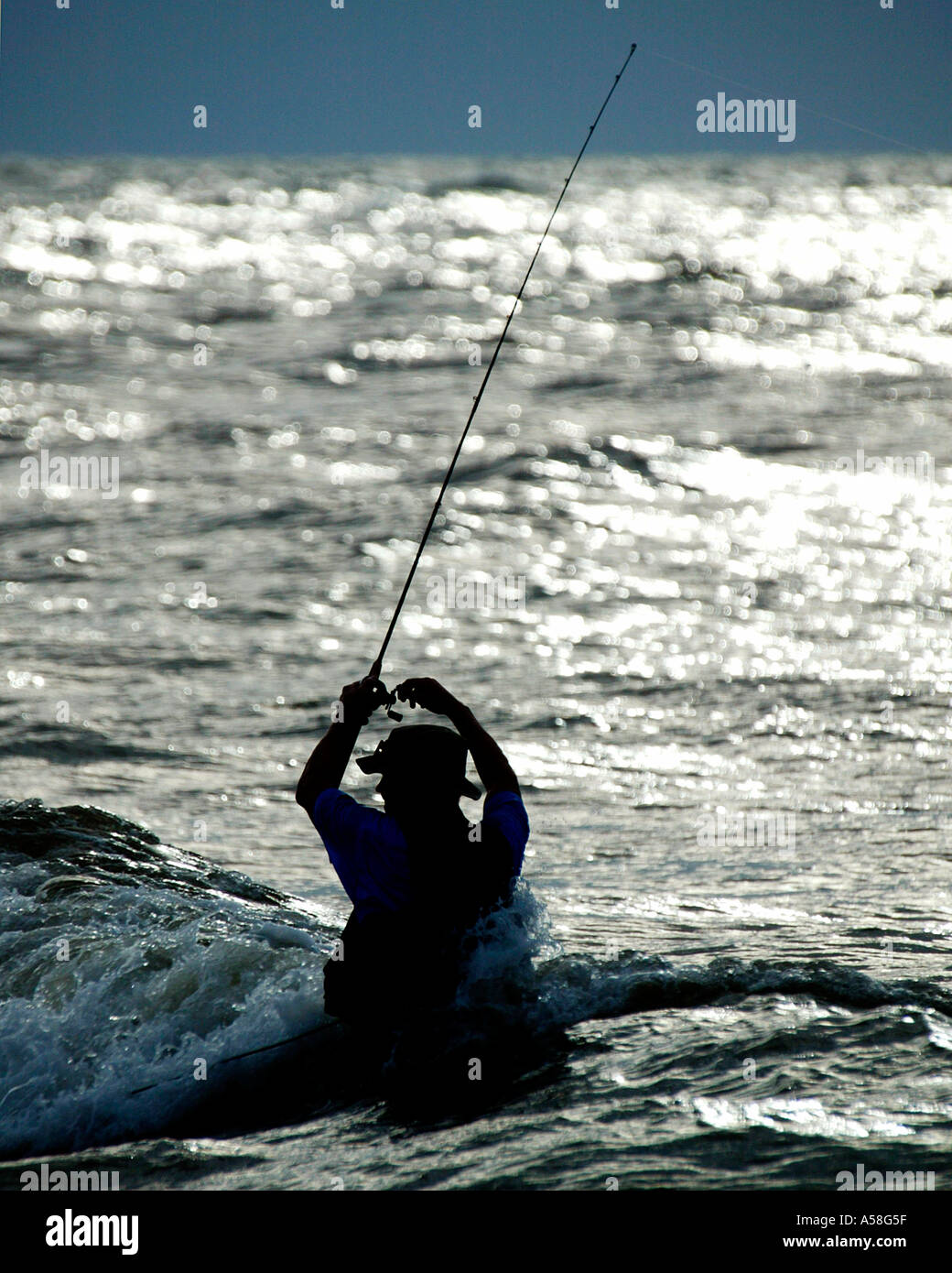 Sunrise Surf Fisherman Foto Stock