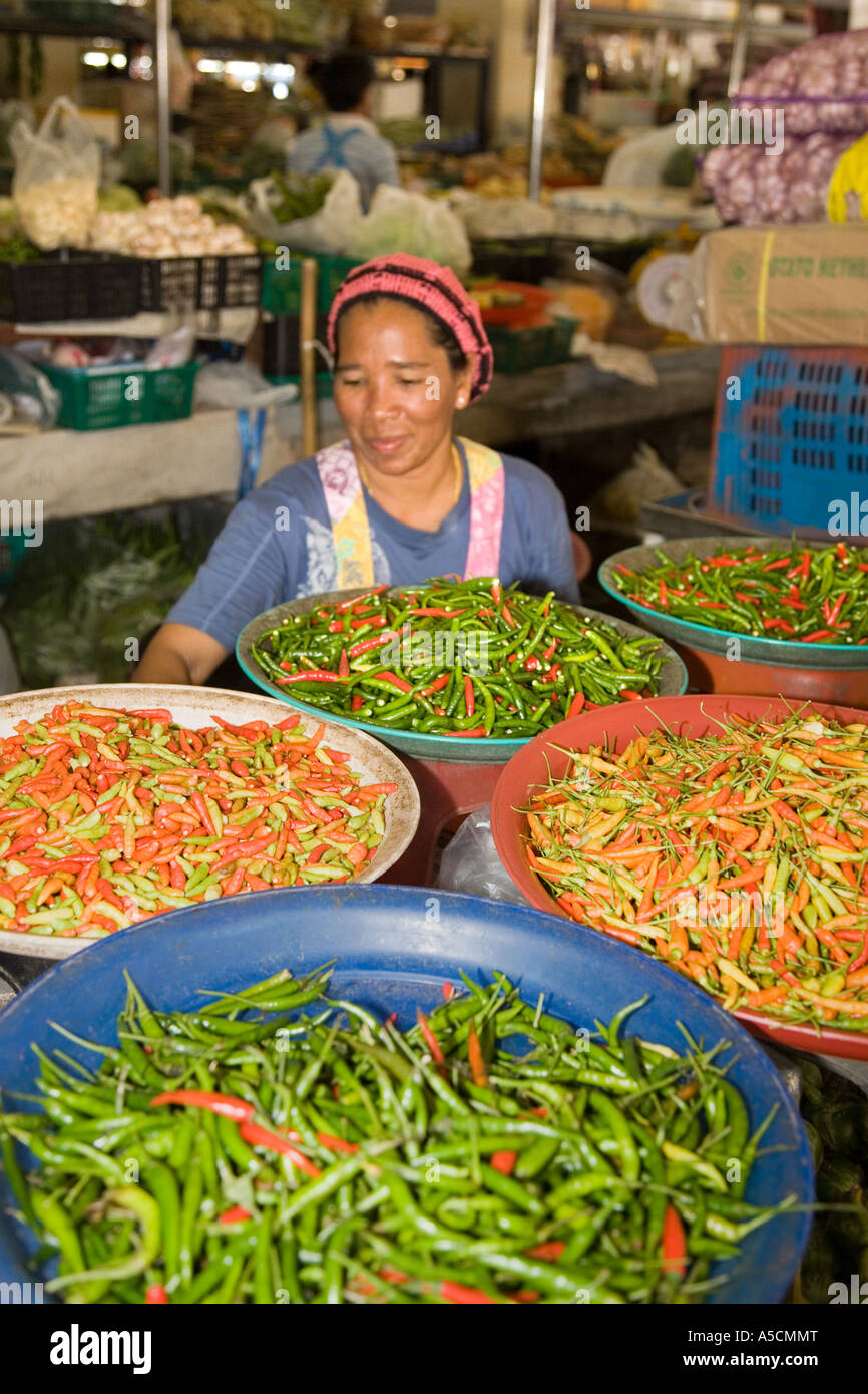 Donna che vende ciotole di una varietà di peperoncino piccante, asiatico, peperoncino vegetale asiatico, tradizionale mercato alimentare al coperto, provincia di Krabi, Thailandia Foto Stock
