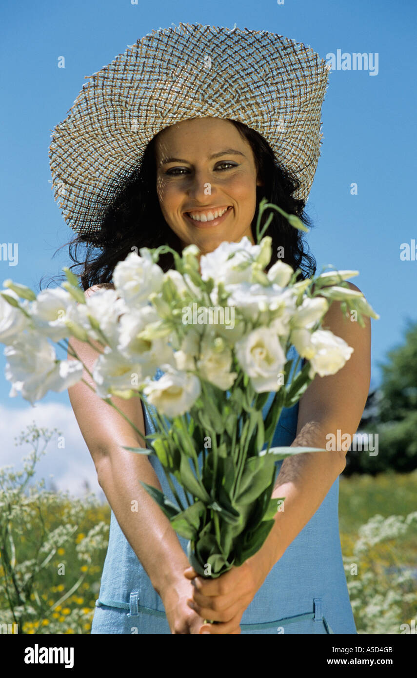 Donna che mantiene i fiori Foto Stock