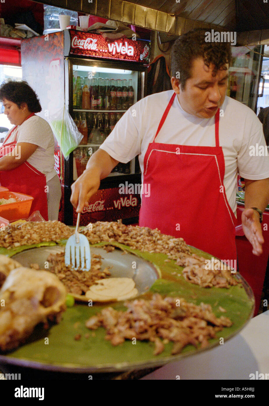 L uomo e la donna la vendita di prelibatezze locali e di fast food snack in una fase di stallo nel Mercardo Merced (mercato), Città del Messico. Foto Stock