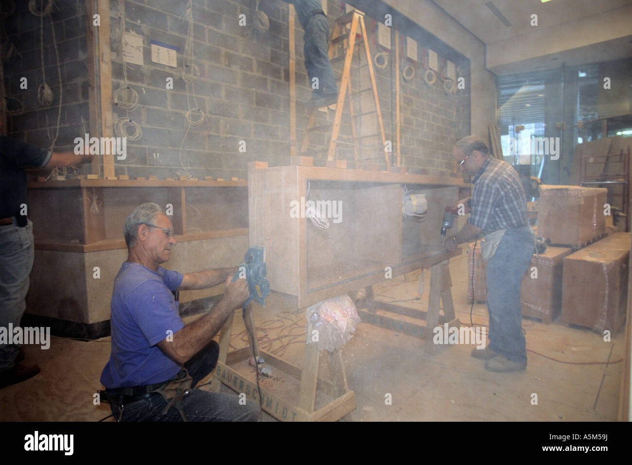 Maestri falegnami lavori su scaffali personalizzati per la lobby in Random House Building di New York City. Foto Stock