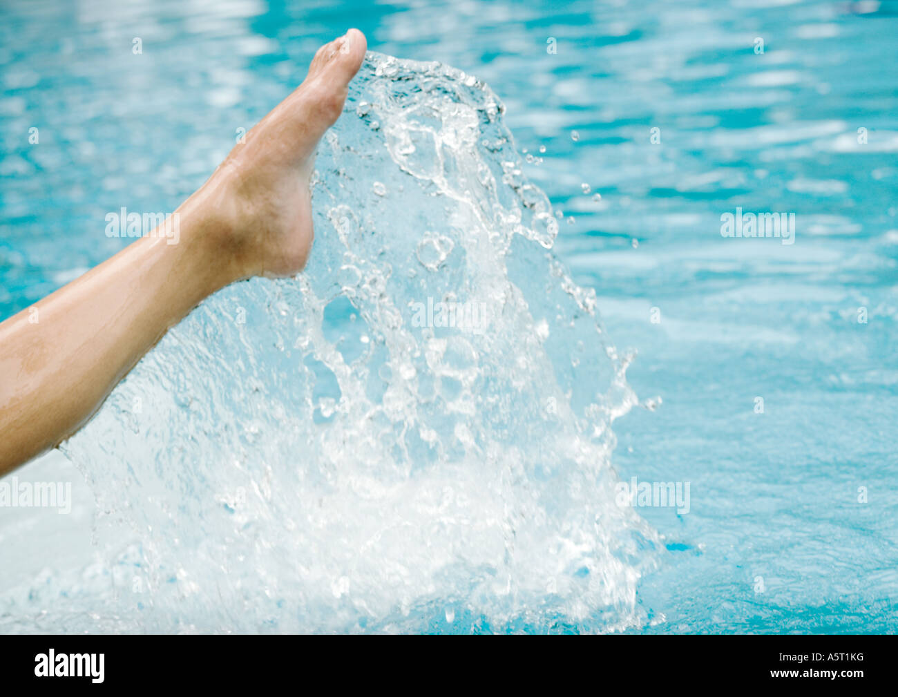 La donna è la gamba gli spruzzi di superficie di acqua, vista ritagliata Foto Stock