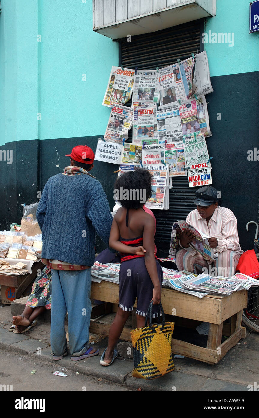 Persone che leggono molte diverse pubblicazioni locali presso un chiosco per le strade di Antananarivo Tana del Madagascar Foto Stock