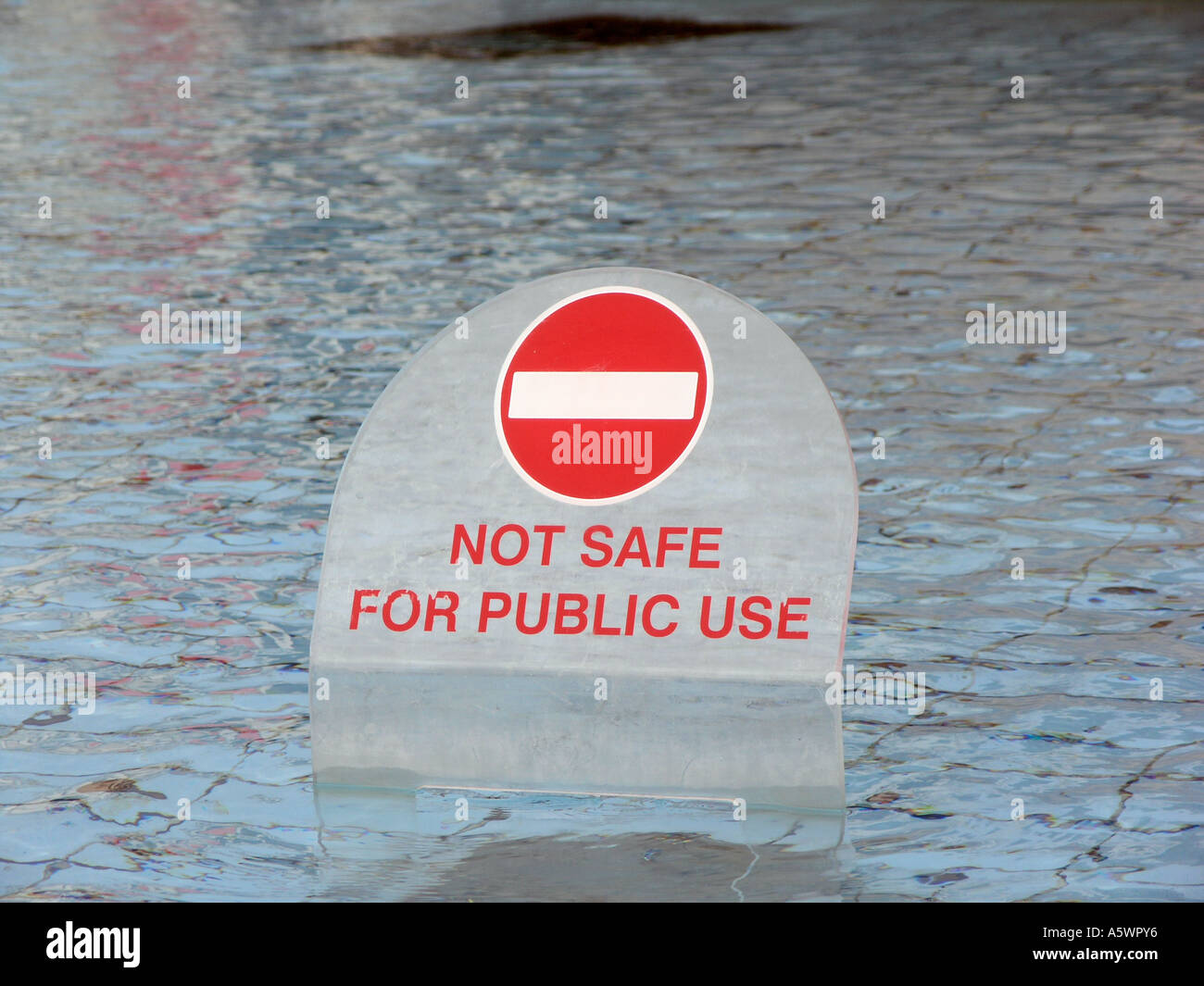 Fontana in Trafalgar Square con un cartello di avvertimento per tenere la gente fuori Londra Inghilterra Foto Stock