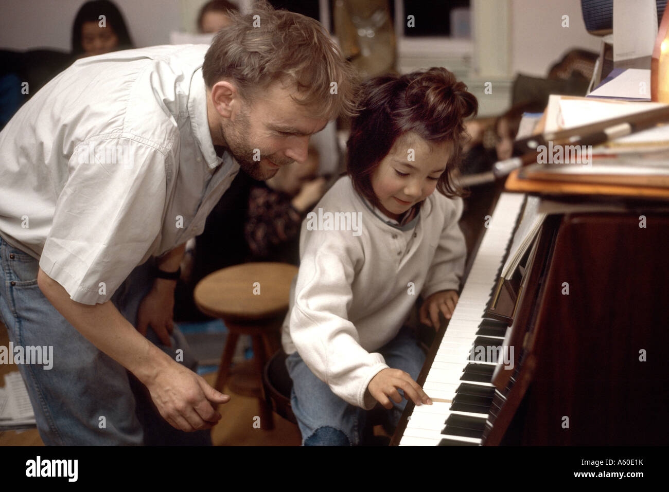 Insegnante di musica dando una lezione di piano al giovane bambina di cinque anni Foto Stock