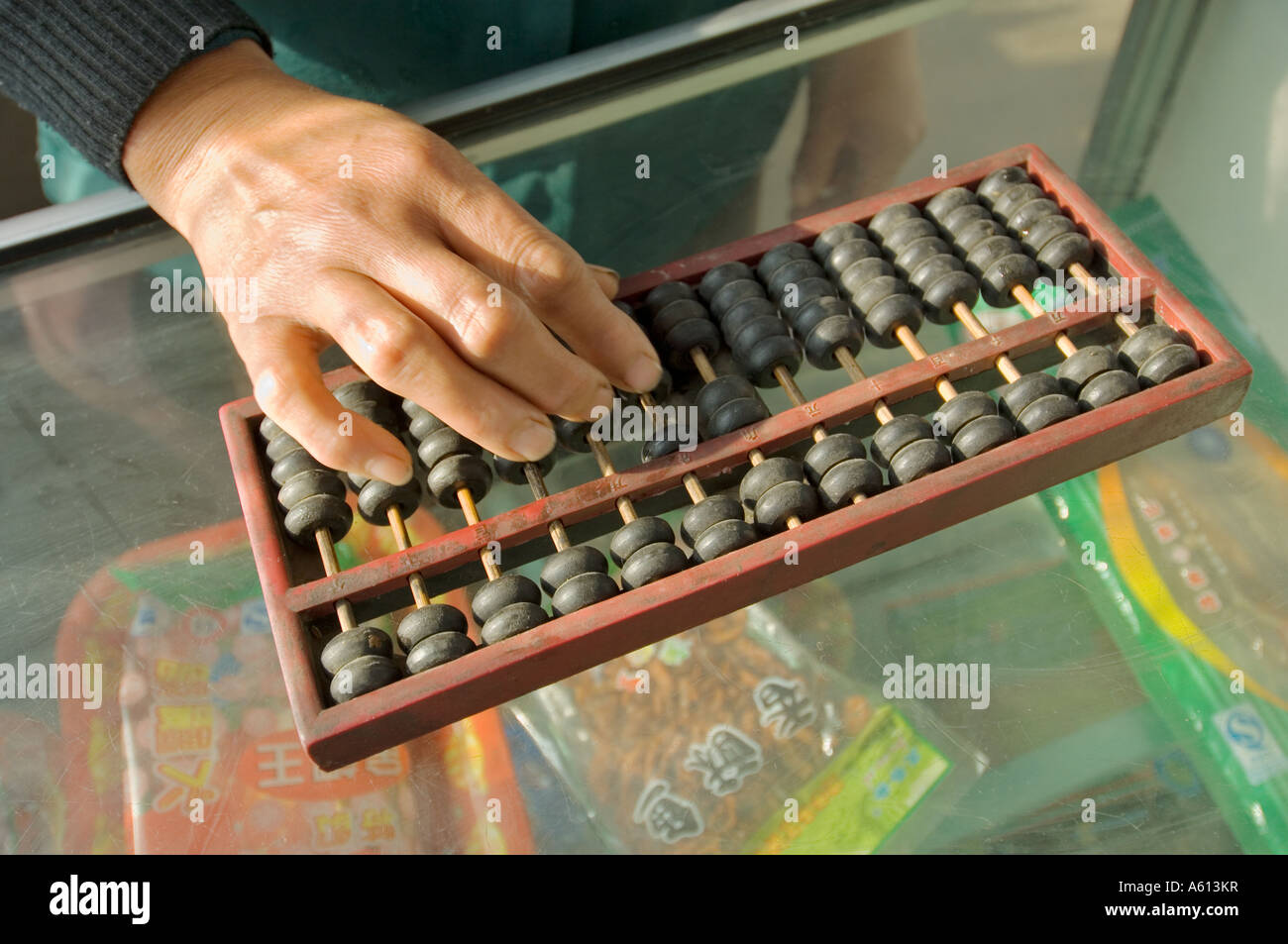 Abacus Macchina di conteggio calcolatrice. Donna mano utilizzando abacus aggiungendo la sottrazione di somma sul banco di negozio in negozio cinese, Cina Foto Stock Abacus Macchina di conteggio calcolatrice. Donna mano utilizzando abacus aggiungendo la sottrazione di somma sul banco di negozio in negozio cinese, Cina Foto Stock