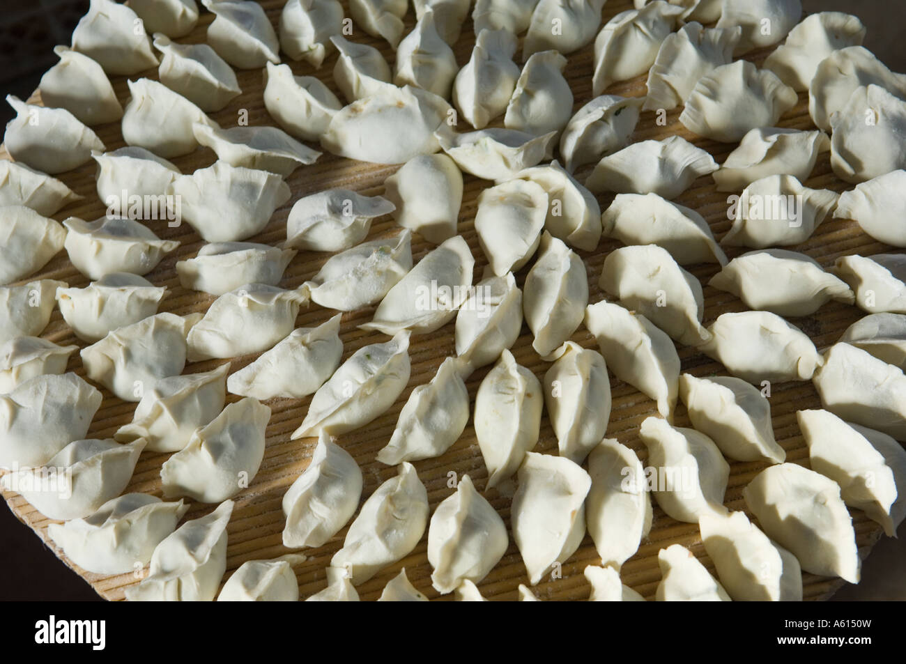 Rendendo tradizionale dim sum gnocchi Cinesi in agriturismo cucina, Provincia di Shandong, Cina Foto Stock