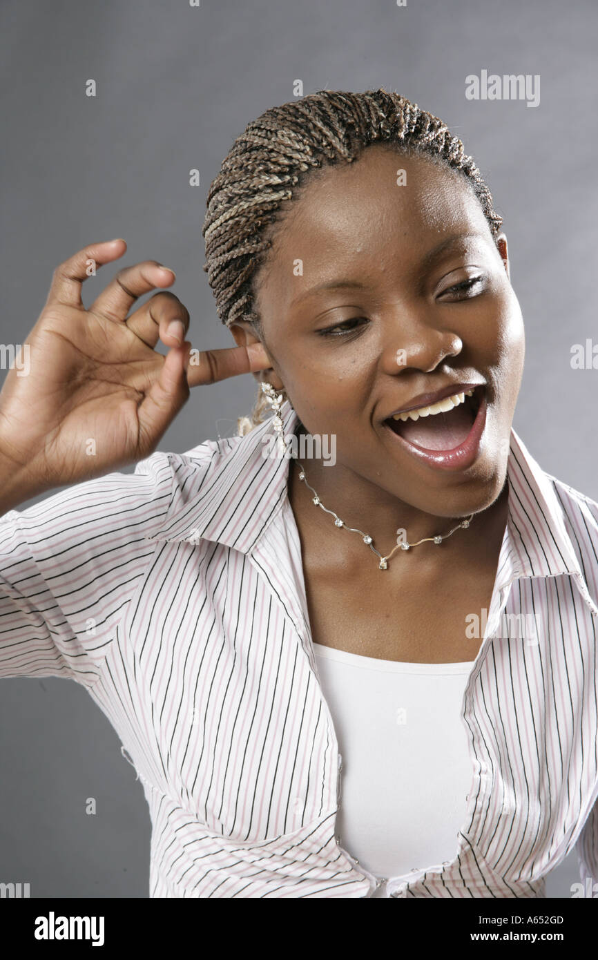 Giovane donna inserendo un dito nel suo orecchio! Foto Stock